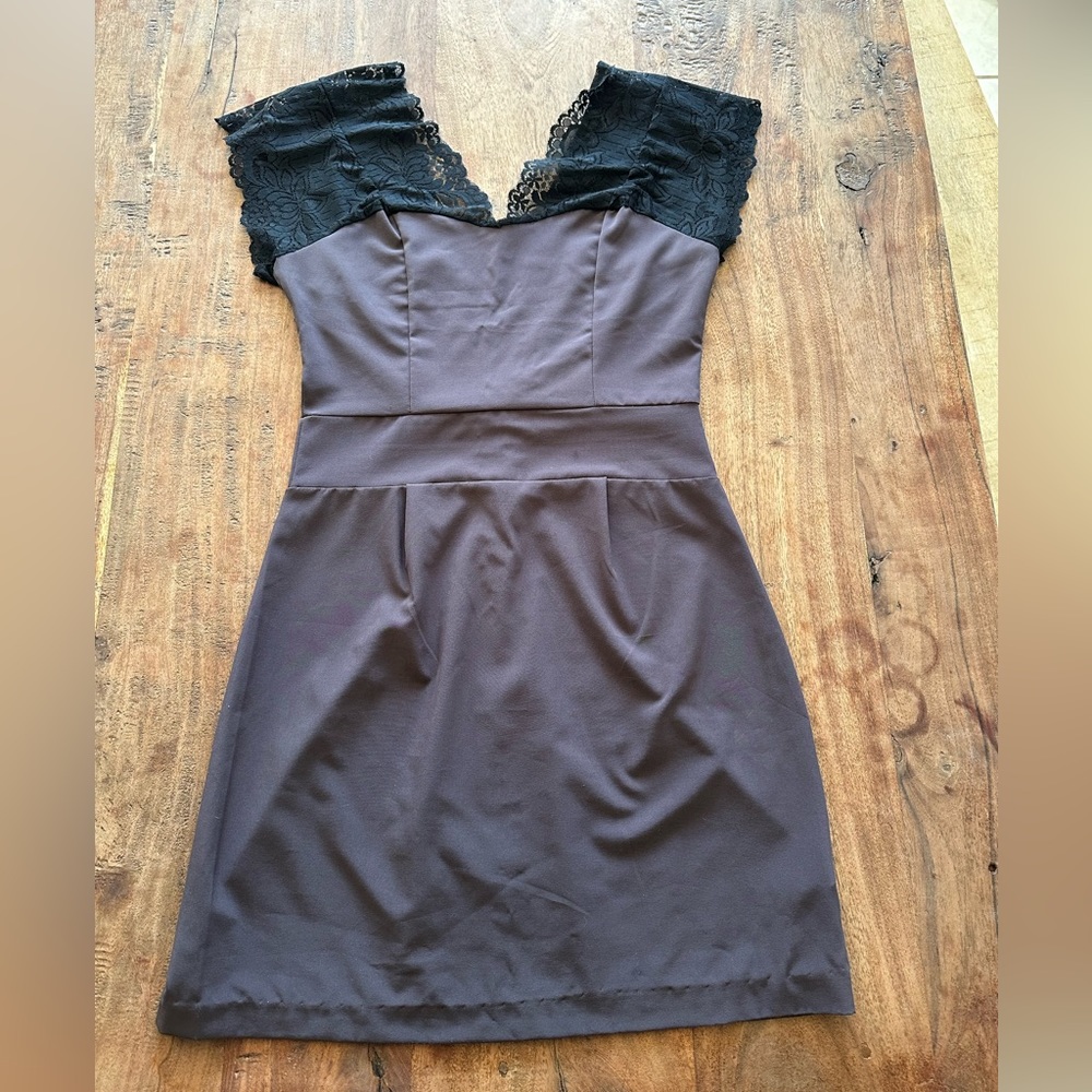 Purple mini dress with lace shoulders and plunging back.